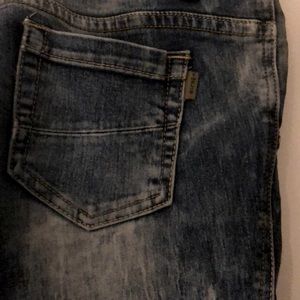 Low-ride acid wash denim jeans.